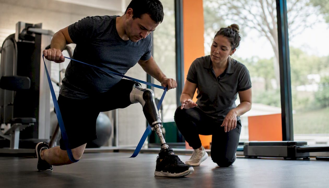 Participant using prosthetic leg for physiotherapy exercise